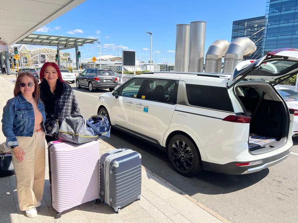 Guests with luggage at a private Sydney Airport transfer